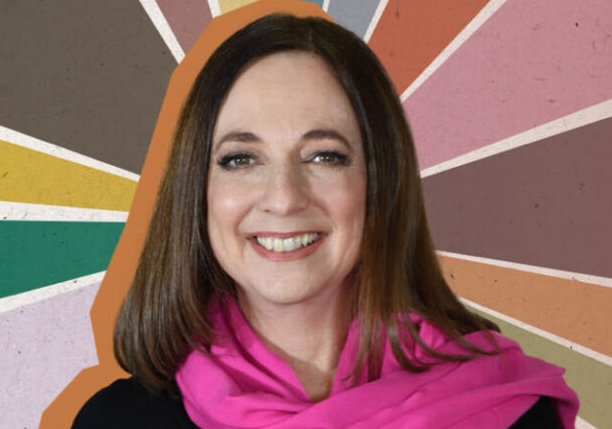 Susan Cain headshot pink scarf with rainbow background