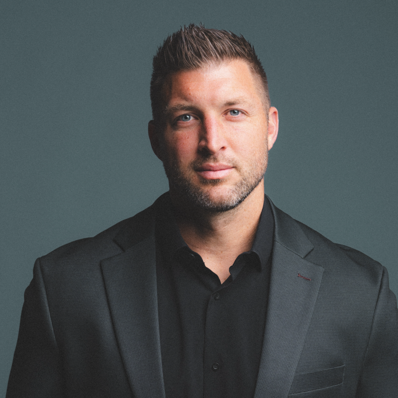 Tim Tebow Headshot wearing a black suit